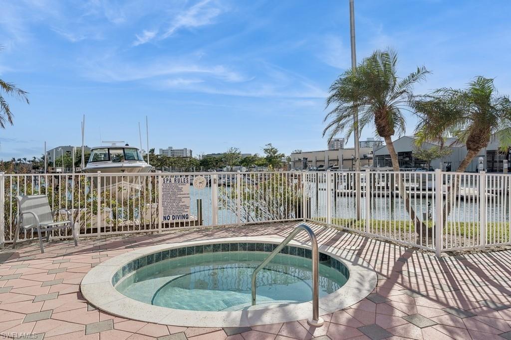 170 Lenell Road, Unit 403 Fort Myers Beach, FL 33931 - Photo 19 of 23 a view of a swimming pool with a lounge chair