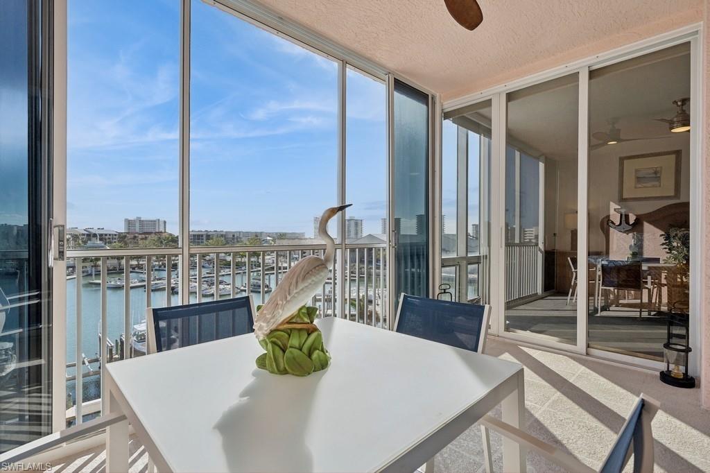 170 Lenell Road, Unit 403 Fort Myers Beach, FL 33931 - Photo 4 of 23 a view of a dining room with furniture window and wooden floor