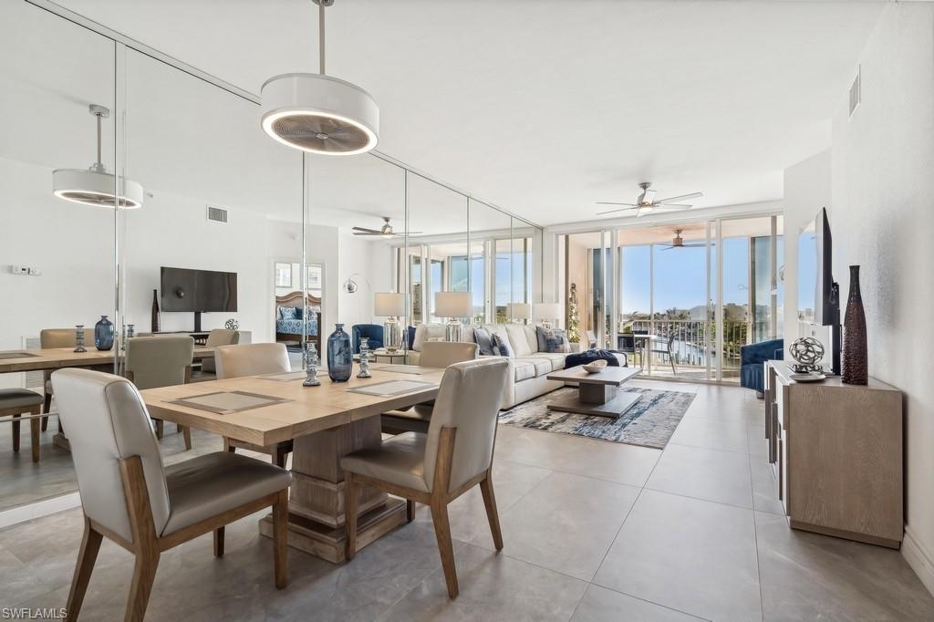 170 Lenell Road, Unit 403 Fort Myers Beach, FL 33931 - Photo 6 of 23 a dining room with furniture a chandelier and wooden floor