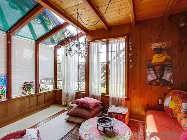 a living room with furniture and a floor to ceiling window