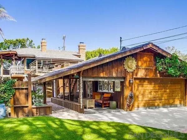 a view of a house with backyard porch and sitting area