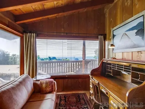 a bedroom with furniture and a window