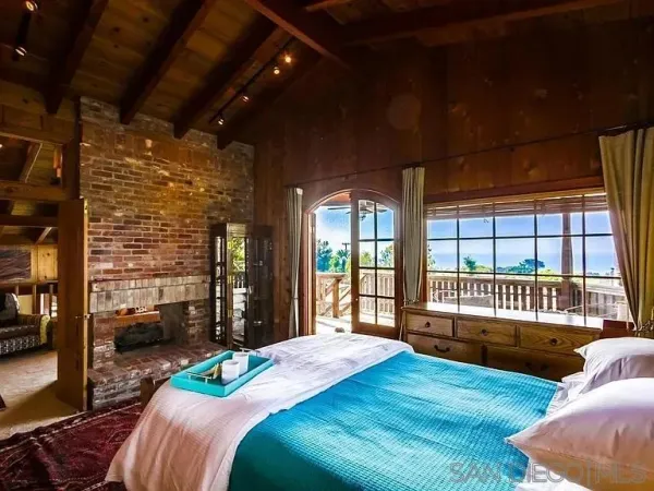 a bedroom with a bed and a large window