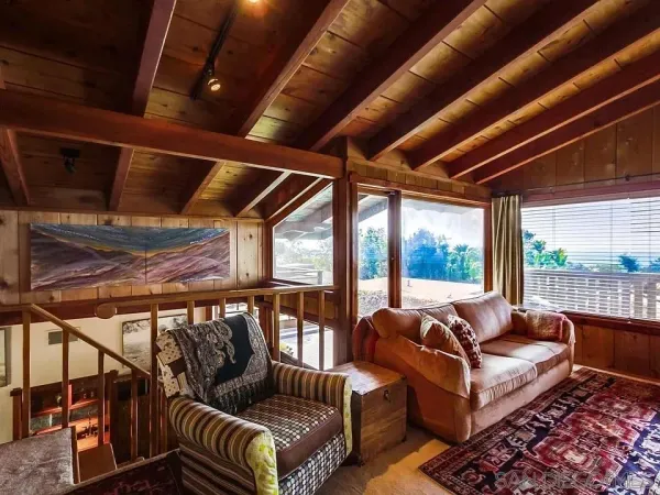 a balcony with furniture and wooden floor