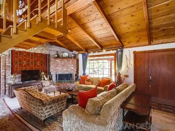 a living room with furniture a fireplace and a table