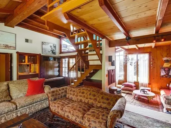 a living room with furniture a large window and a rug