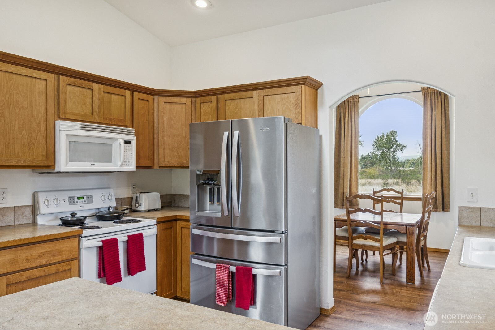 7245 185th Lane Southwest Rochester, WA 98579 - Photo 7 of 29 a kitchen with stainless steel appliances granite countertop a refrigerator and a stove top oven