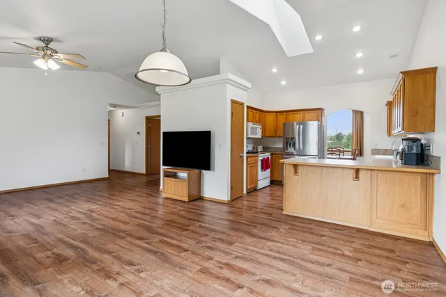 a view of a kitchen with furniture and a ceiling fan