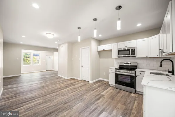 a view of kitchen with sink and wooden floor
