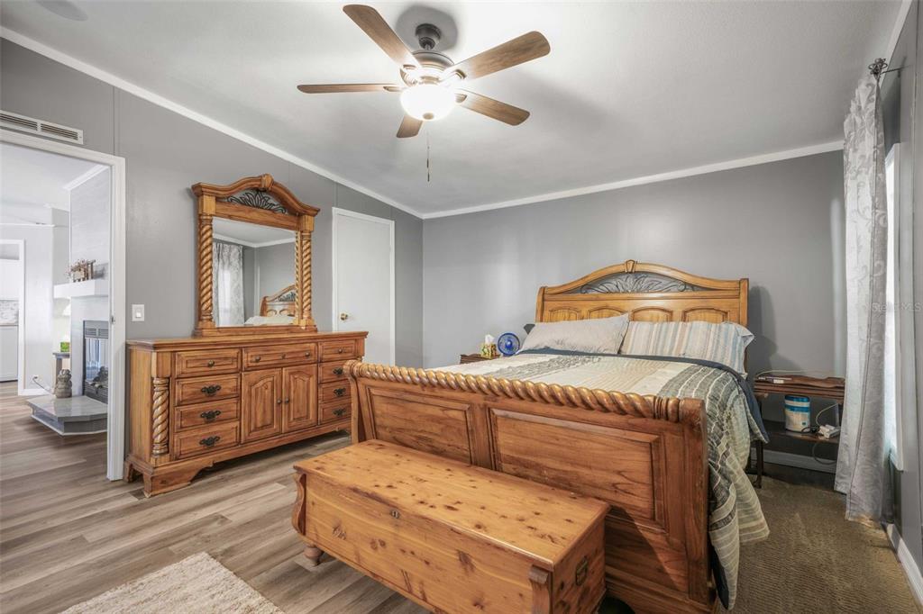 6716 West Riverbend Road Dunnellon, FL 34433 - Photo 25 of 75 a bedroom with a bed a dresser and mirror