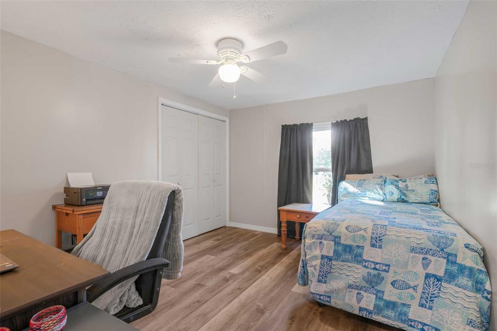 6716 West Riverbend Road Dunnellon, FL 34433 - Photo 30 of 75 a bedroom with a bed and wooden floor