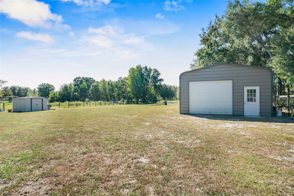 6716 West Riverbend Road Dunnellon, FL 34433 - Photo 3 of 75 a backyard of a house with lots of green space