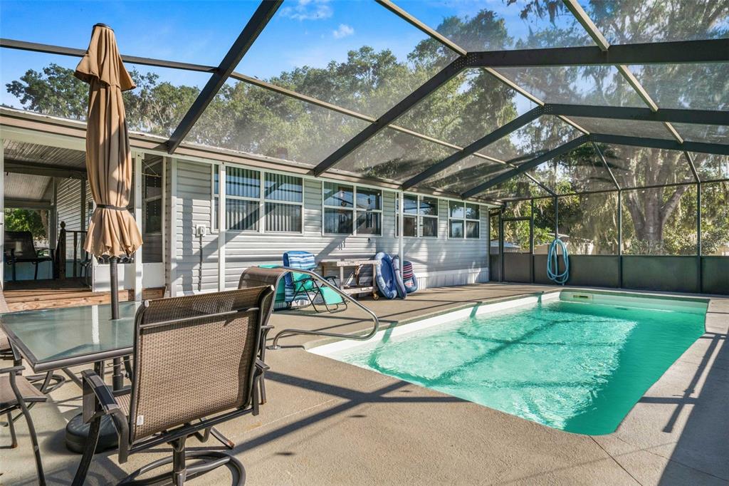 6716 West Riverbend Road Dunnellon, FL 34433 - Photo 41 of 75 a view of a patio with table and chairs and potted plants