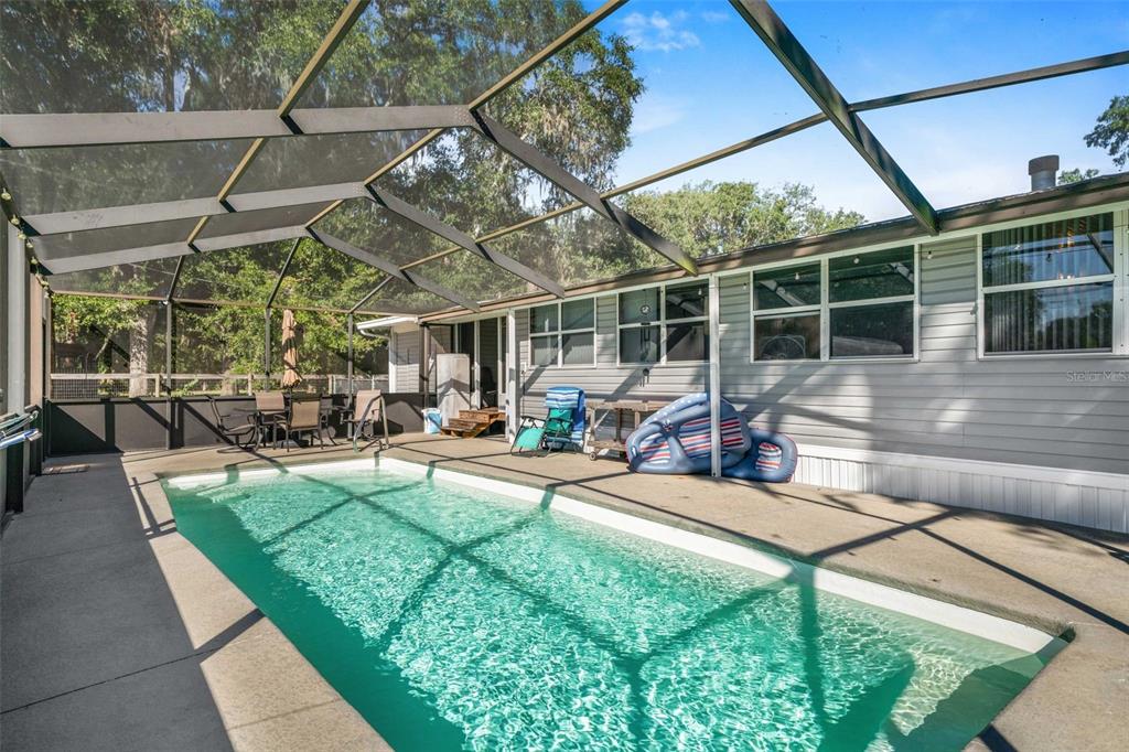 6716 West Riverbend Road Dunnellon, FL 34433 - Photo 42 of 75 a view of a backyard with sitting area