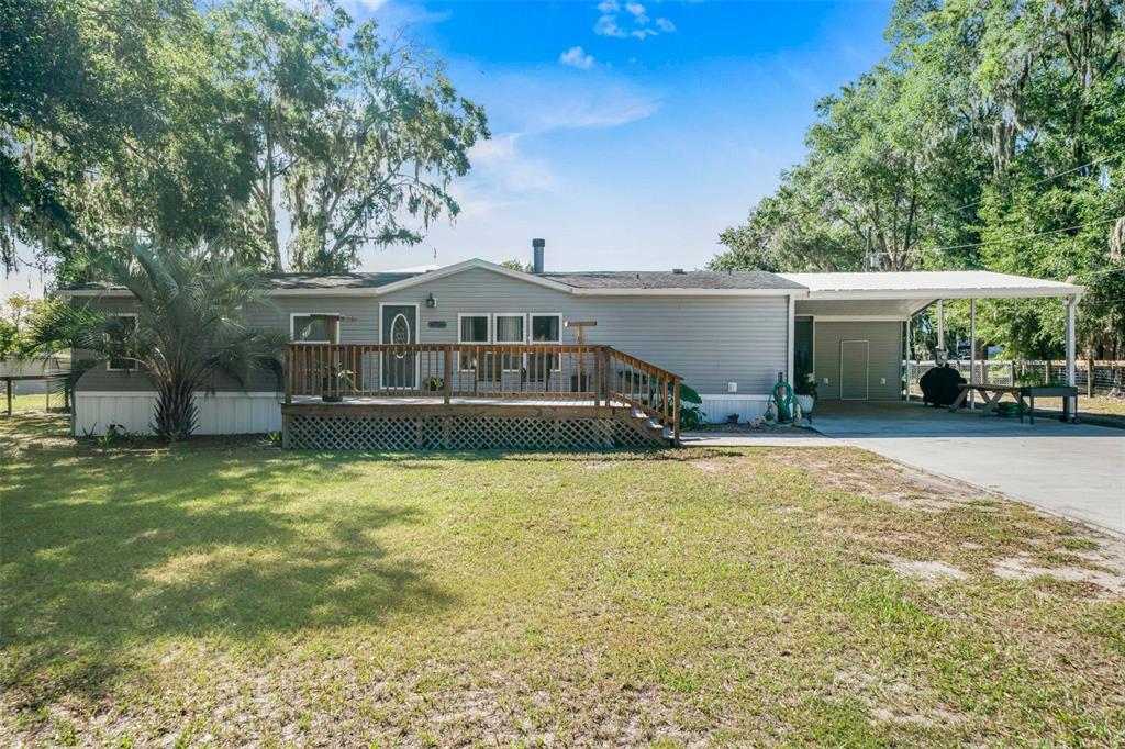 6716 West Riverbend Road Dunnellon, FL 34433 - Photo 8 of 75 a front view of a house with a yard and garage
