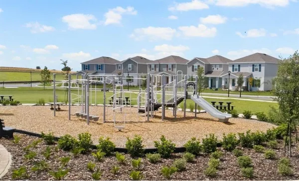 a view of a house with a yard and sitting area