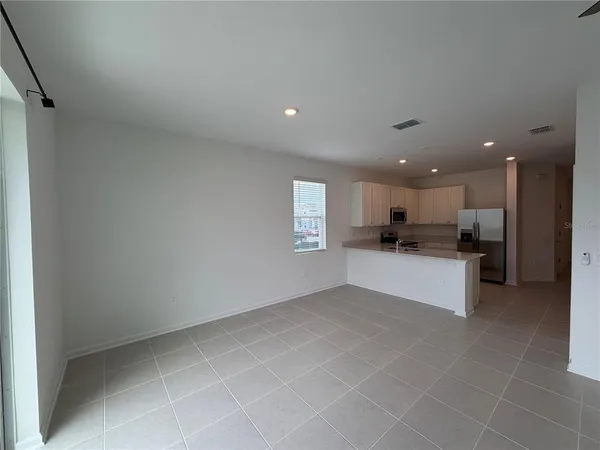 a view of kitchen with kitchen island sink and center island