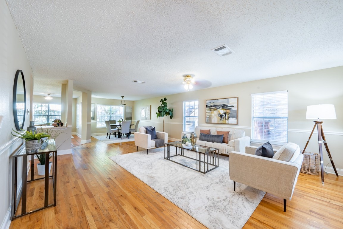 a living room with fireplace furniture and a wooden floor