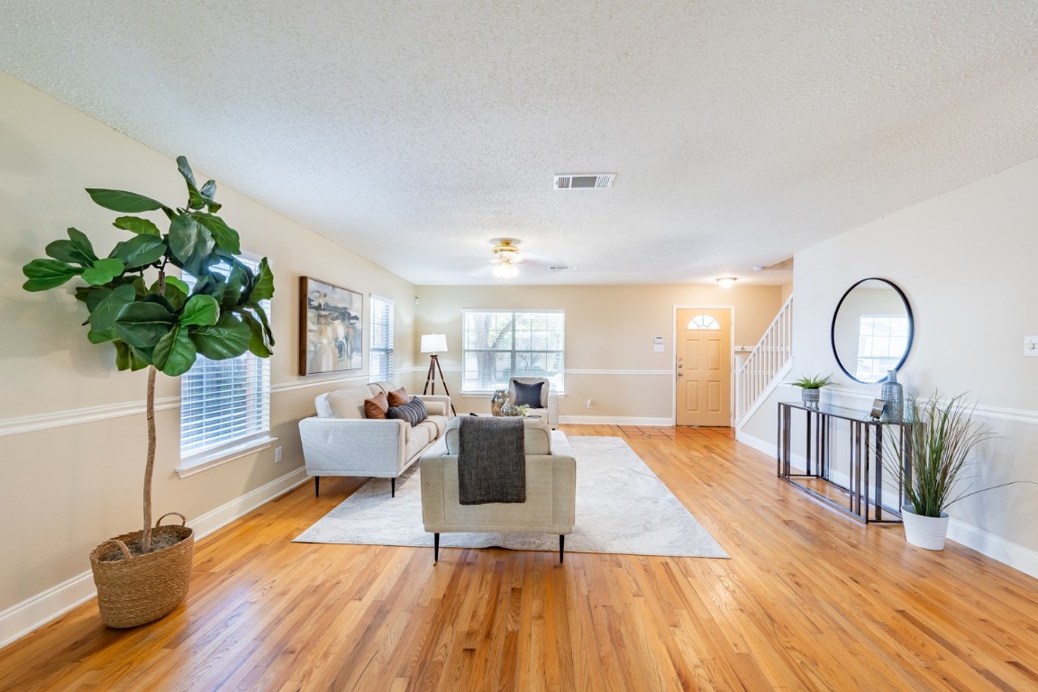 2017 Carriage Club Drive Cedar Park, TX 78613 - Photo 12 of 35 a living room with furniture a potted plant and a chandelier