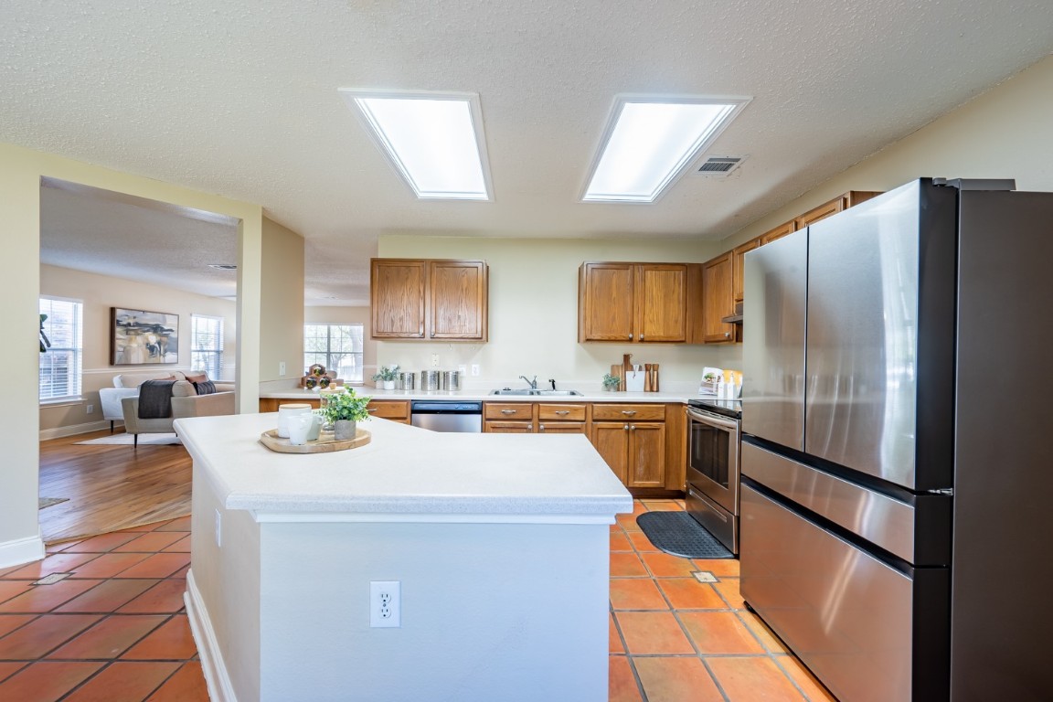 2017 Carriage Club Drive Cedar Park, TX 78613 - Photo 13 of 35 a kitchen with refrigerator a stove and cabinets