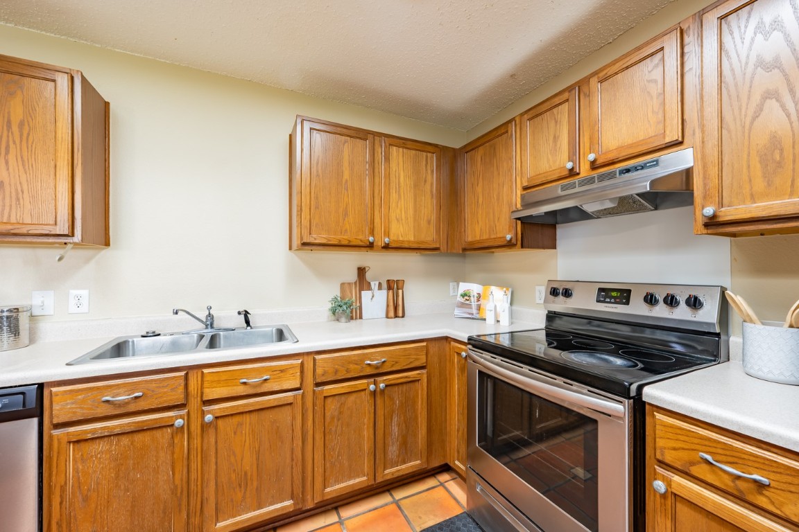 2017 Carriage Club Drive Cedar Park, TX 78613 - Photo 14 of 35 a kitchen with stainless steel appliances granite countertop a sink a stove and cabinets