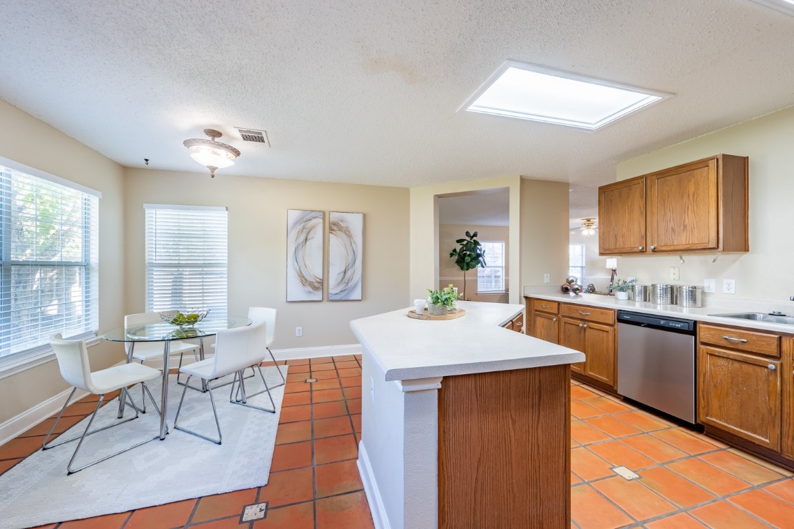2017 Carriage Club Drive Cedar Park, TX 78613 - Photo 16 of 35 a very nice looking open kitchen with granite countertop a stove a sink a dining table and chairs