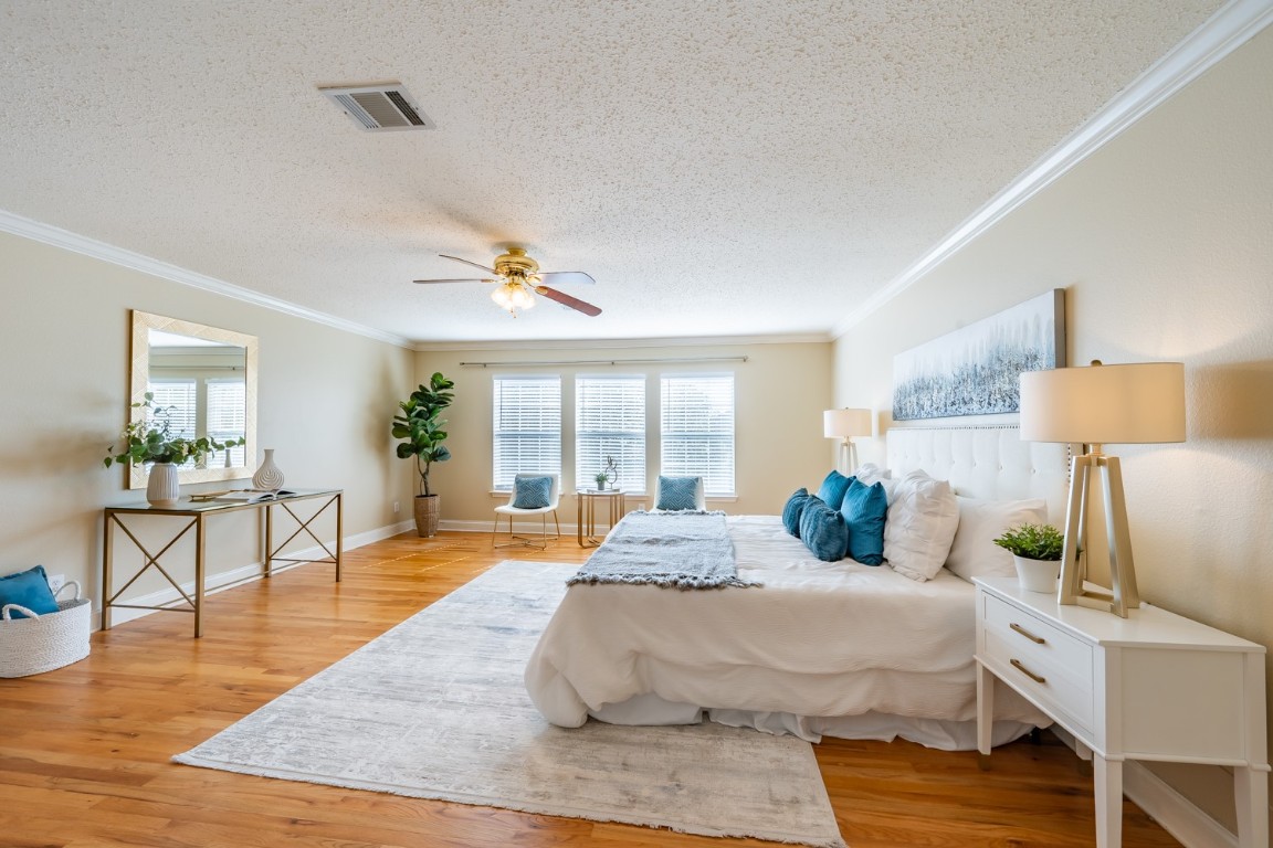 2017 Carriage Club Drive Cedar Park, TX 78613 - Photo 21 of 35 a large bedroom with a bed and wooden floor