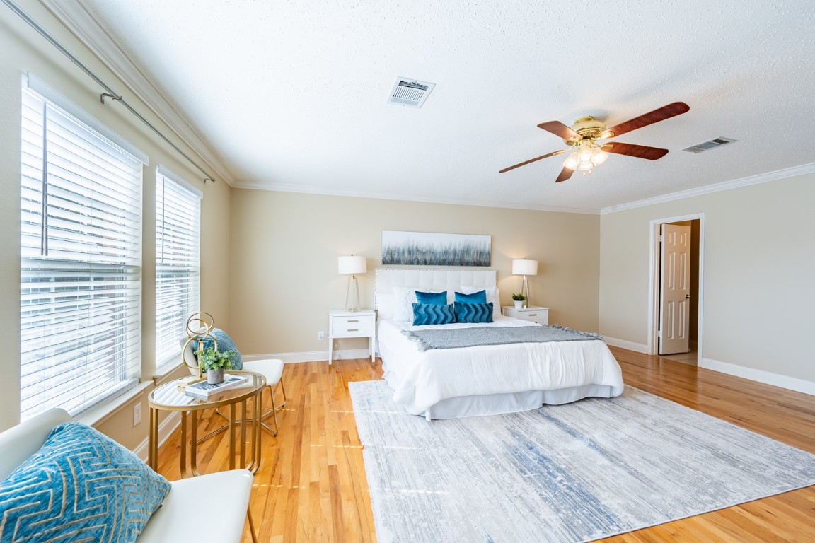 2017 Carriage Club Drive Cedar Park, TX 78613 - Photo 22 of 35 a bedroom with a bed and a chandelier