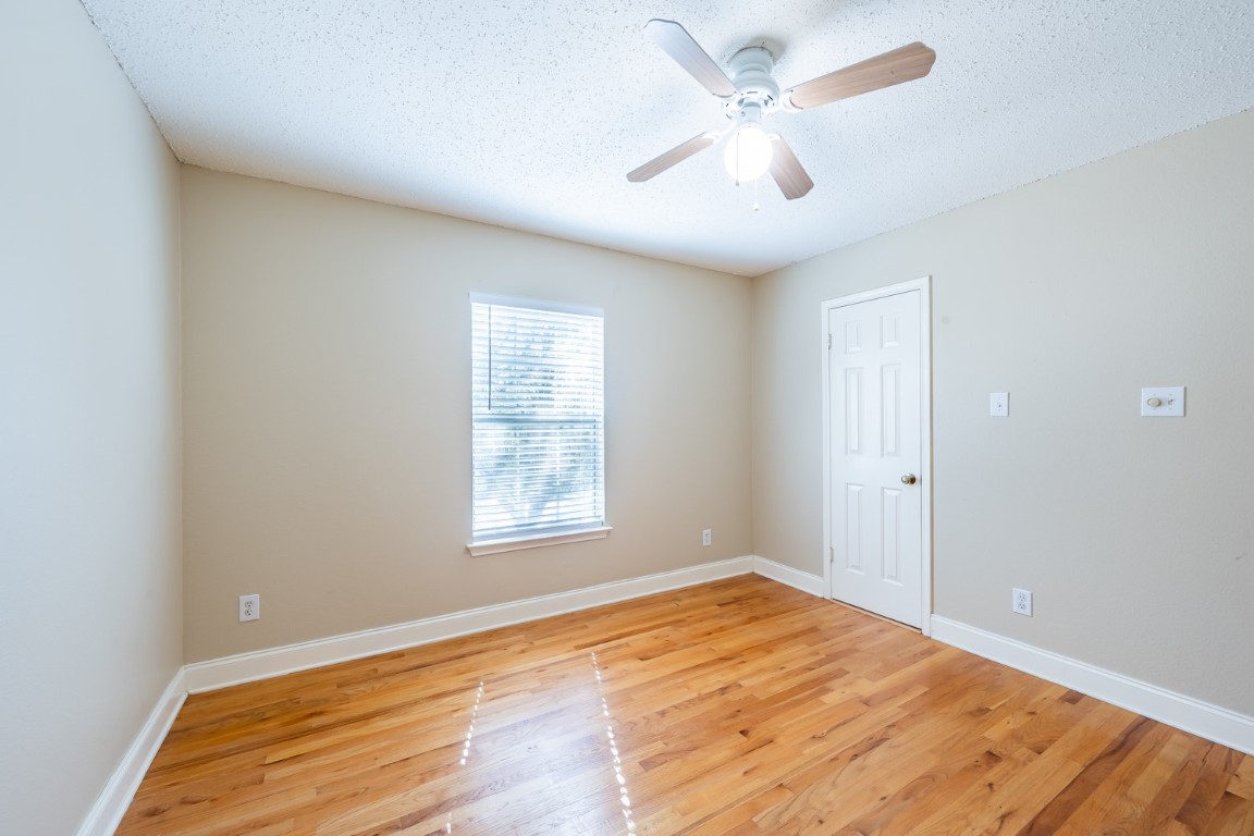 2017 Carriage Club Drive Cedar Park, TX 78613 - Photo 28 of 35 an empty room with wooden floor and ceiling fan