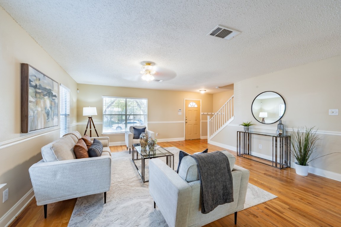 2017 Carriage Club Drive Cedar Park, TX 78613 - Photo 8 of 35 a living room with furniture a lamp wooden floor and a large window