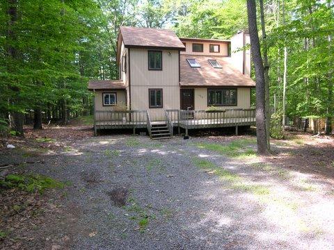 1303 Selig Road Pocono Lake, PA 18347 - Photo 1 of 1 a view of a house with a yard and sitting area