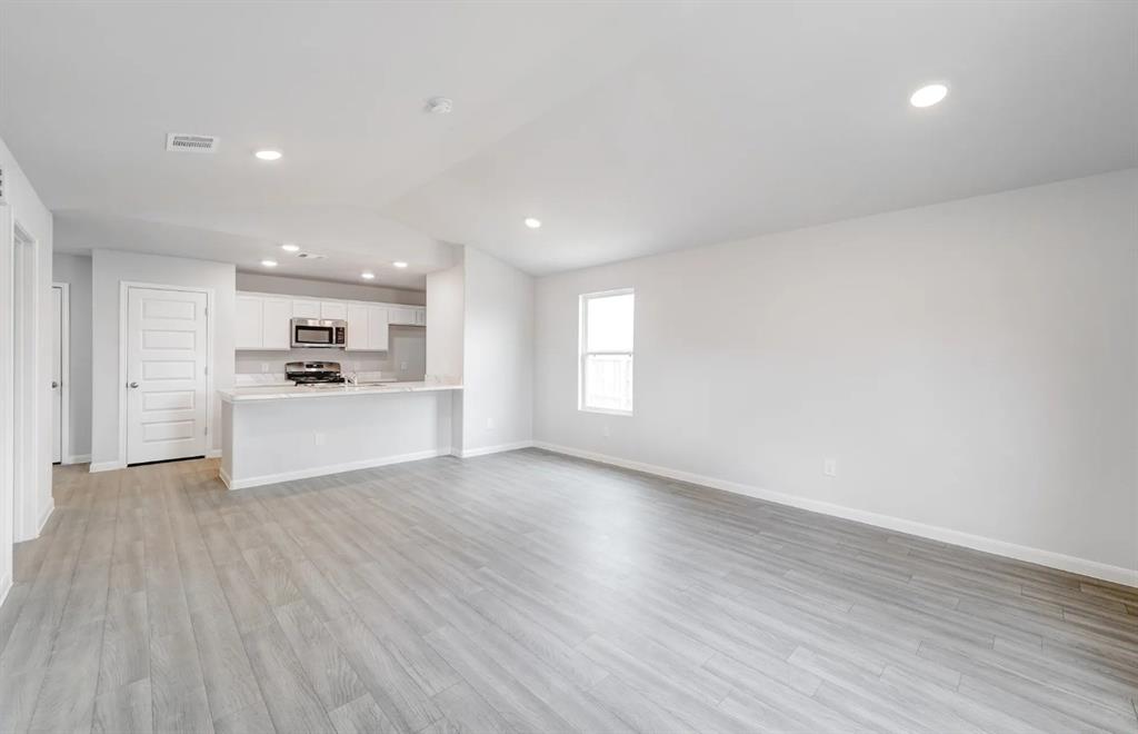 350 Azalea Trail Granbury, TX 76048 - Photo 7 of 7 a view of a kitchen with a sink and a refrigerator