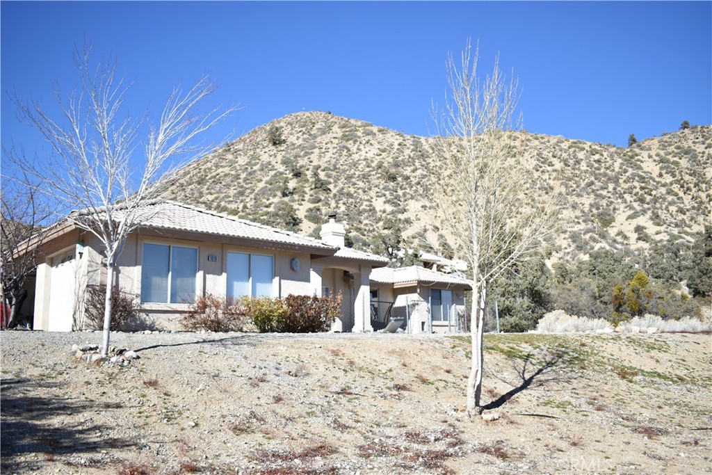 1510 Desert Front Road Pinon Hills, CA 92372 - Photo 1 of 1 a view of a house with a yard
