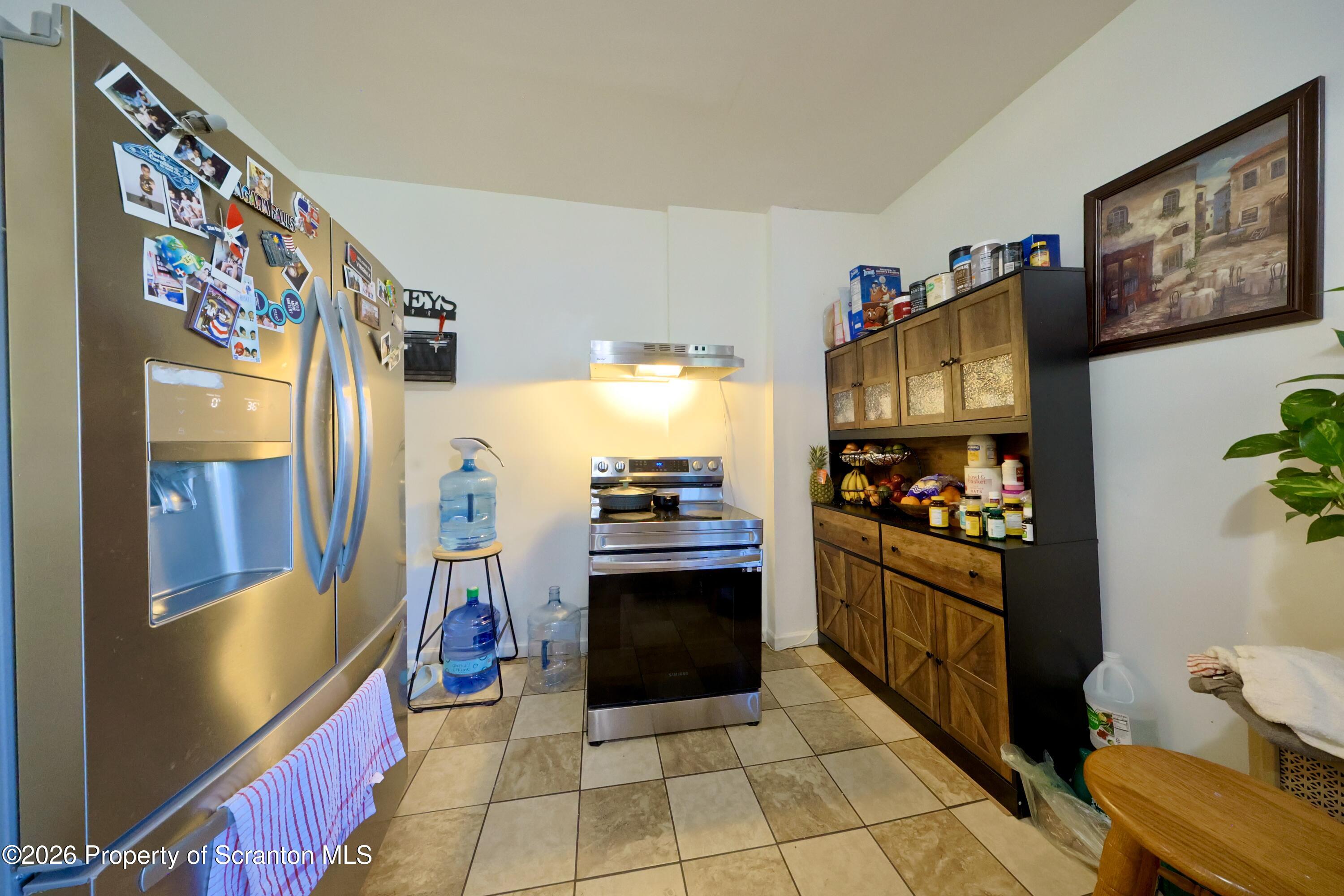 1016-1018 Diamond Avenue Scranton, PA 18508 - Photo 5 of 15 a kitchen with stainless steel appliances granite countertop a refrigerator and a stove