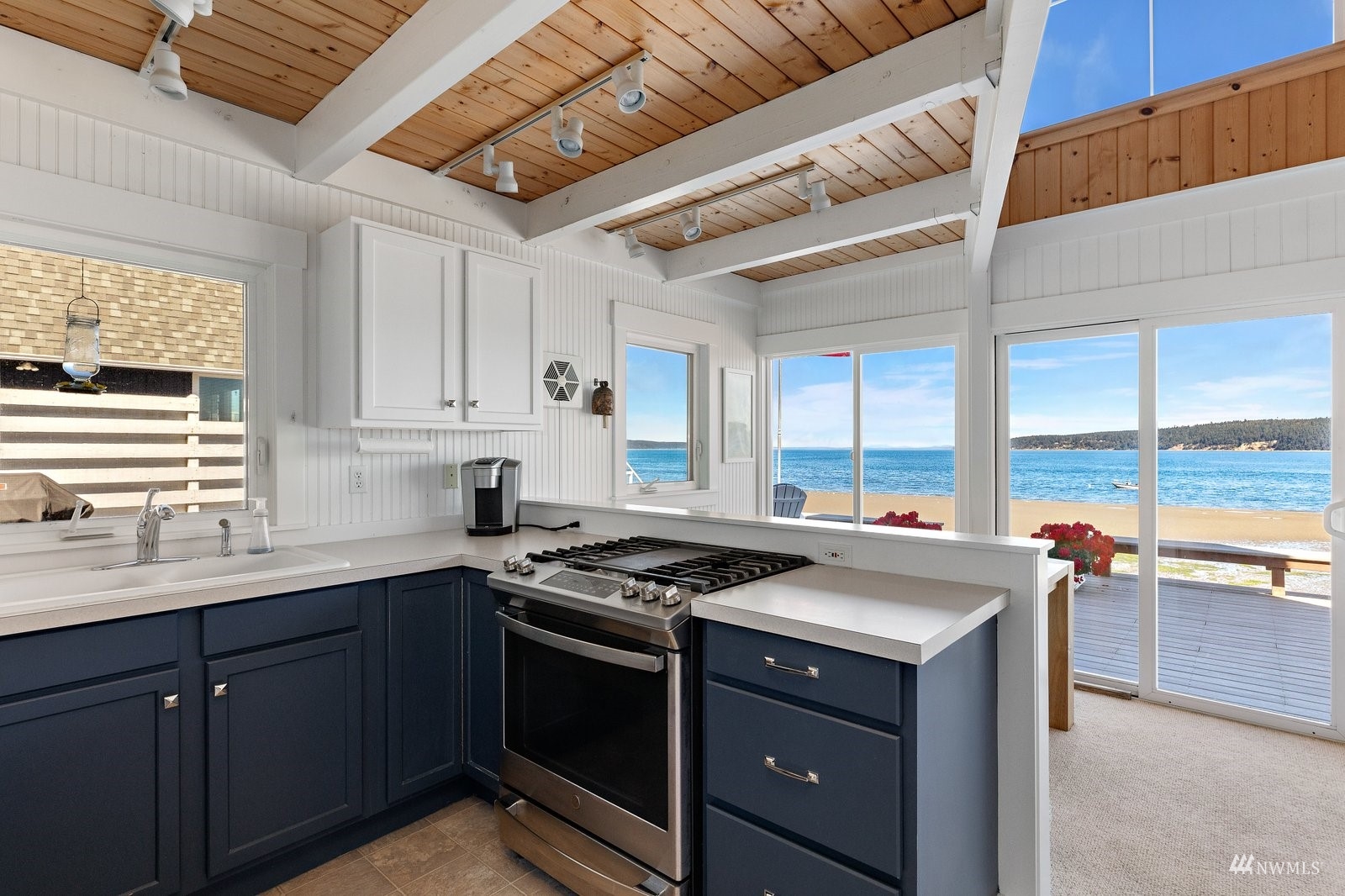 2139 Eastpoint Drive Langley, WA 98260 - Photo 12 of 40 a kitchen with a sink stove and cabinets