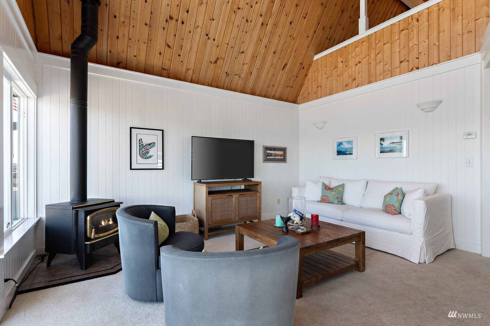 2139 Eastpoint Drive Langley, WA 98260 - Photo 16 of 40 a living room with furniture a flat screen tv and a window