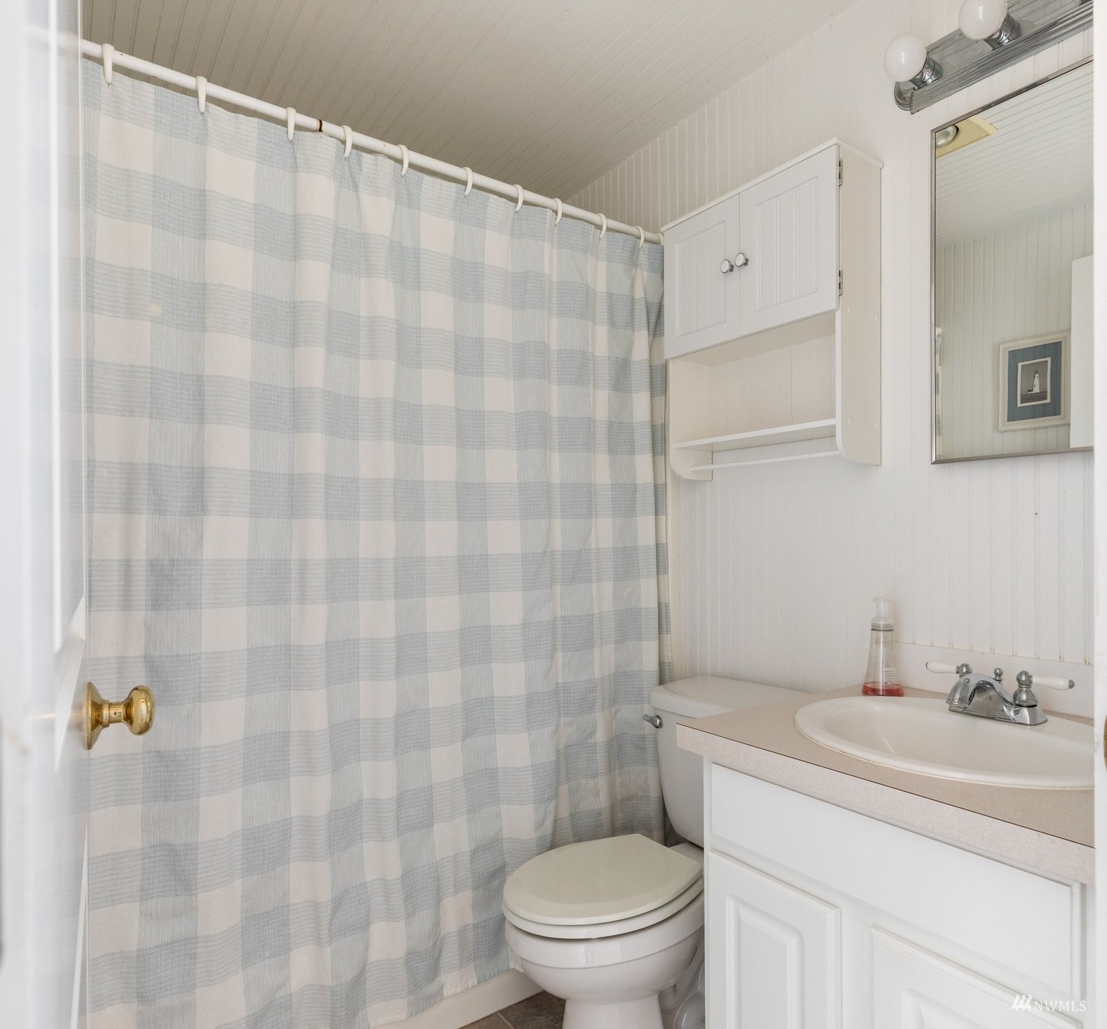 2139 Eastpoint Drive Langley, WA 98260 - Photo 19 of 40 a bathroom with a sink a toilet and shower curtain
