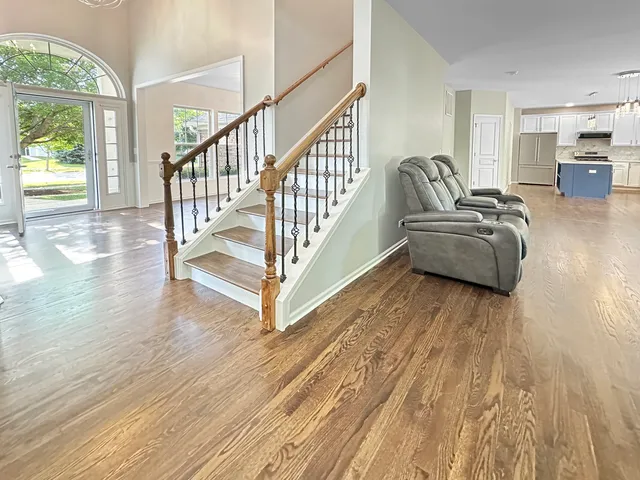 a living room with furniture and a wooden floor