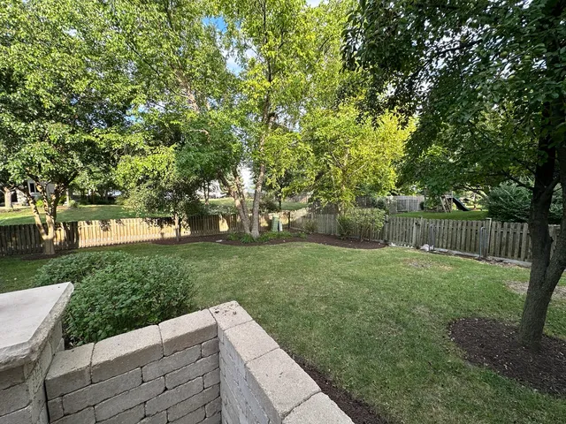 a view of a backyard with sitting area