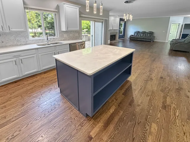 a living room with furniture a window and wooden floor