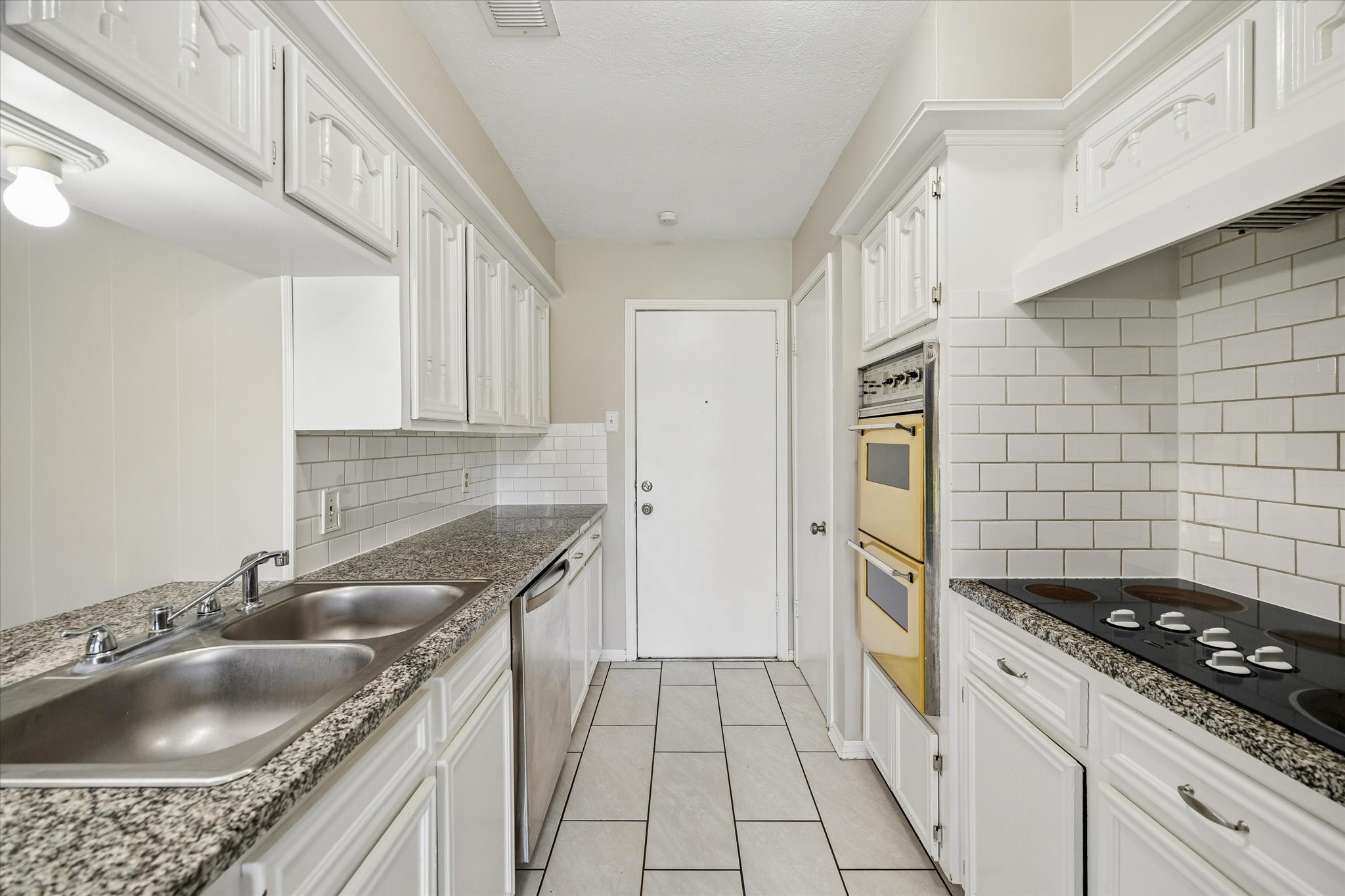 25114 Spring Ridge Drive Spring, TX 77386 - Photo 11 of 24 a kitchen that has a sink and a stove