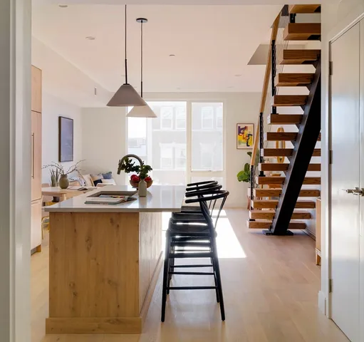 a dining hall with a dining table chairs and a chandelier