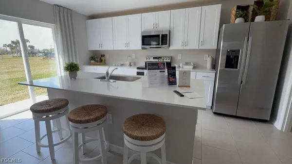 a kitchen with a sink a stove and a refrigerator