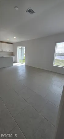 a kitchen with stainless steel appliances kitchen island granite countertop a sink and white cabinets