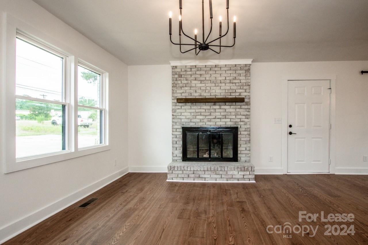 4892 Highway 16 Denver, NC 28037 - Photo 13 of 46 a view of a livingroom with a fireplace and window
