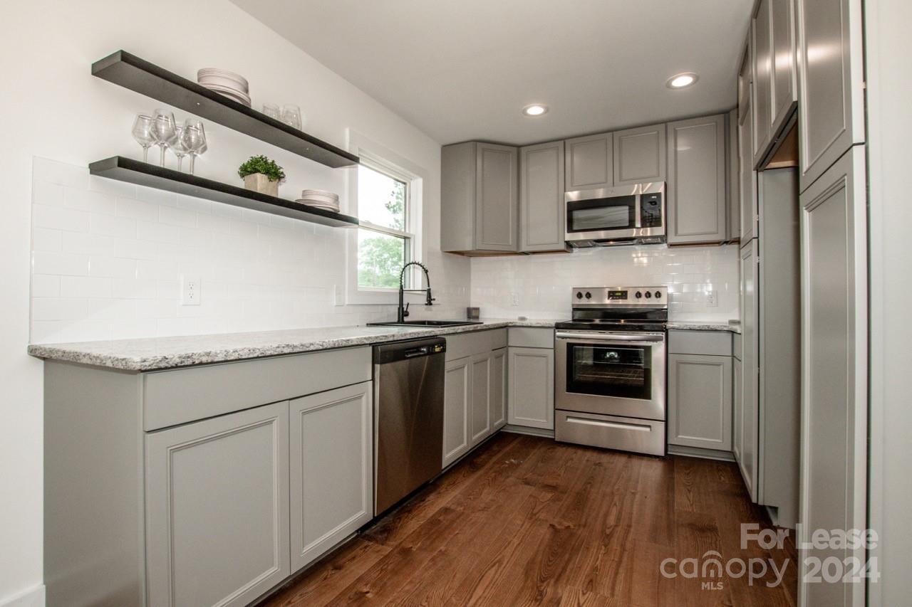 4892 Highway 16 Denver, NC 28037 - Photo 24 of 46 a kitchen with stainless steel appliances a sink dishwasher stove refrigerator and microwave