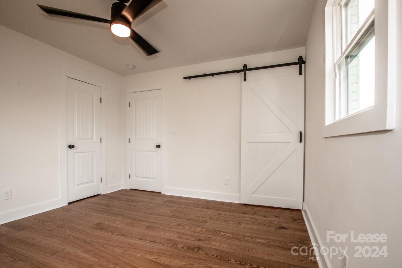4892 Highway 16 Denver, NC 28037 - Photo 28 of 46 a view of an empty room with a window and wooden floor
