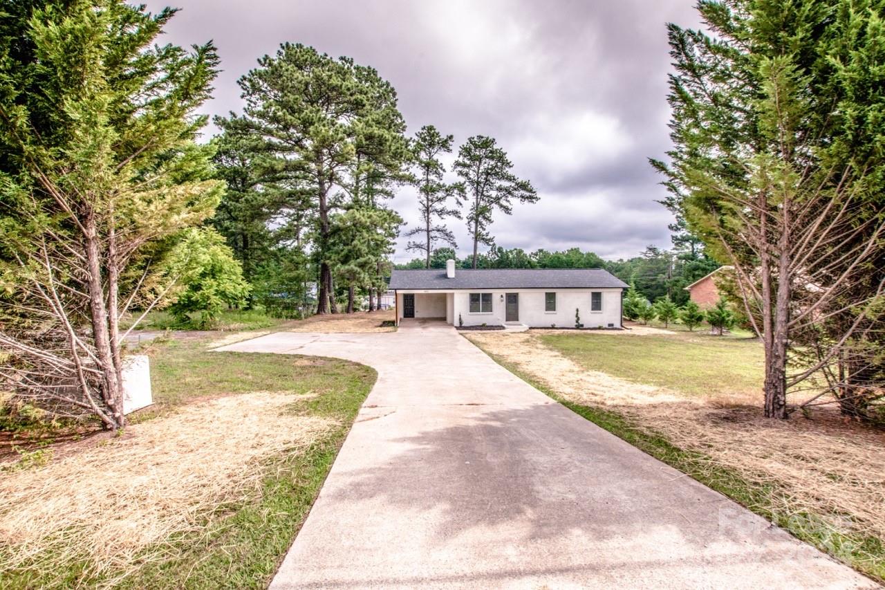 4892 Highway 16 Denver, NC 28037 - Photo 3 of 46 a view of swimming pool with large trees and a big yard