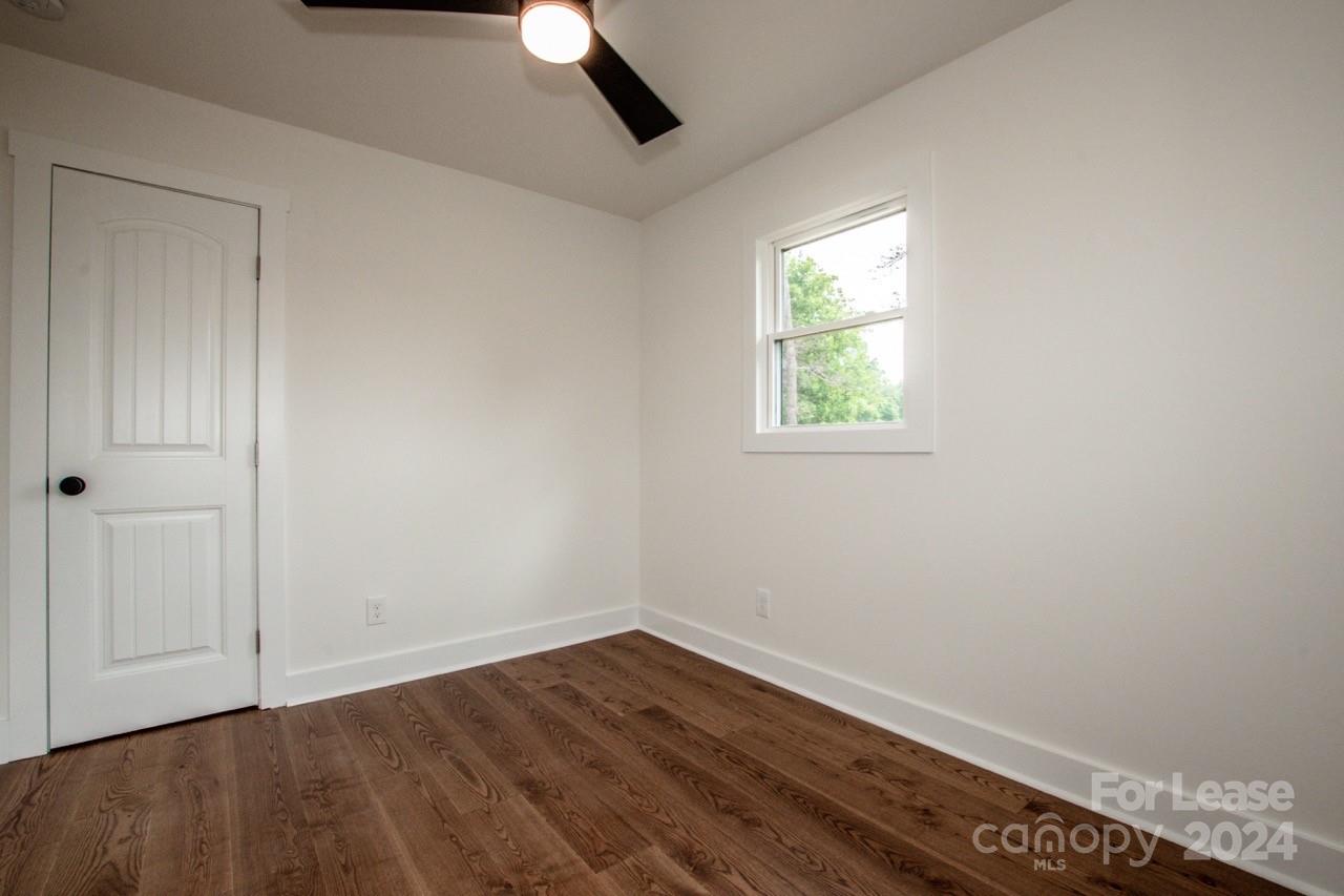 4892 Highway 16 Denver, NC 28037 - Photo 33 of 46 an empty room with wooden floor and windows