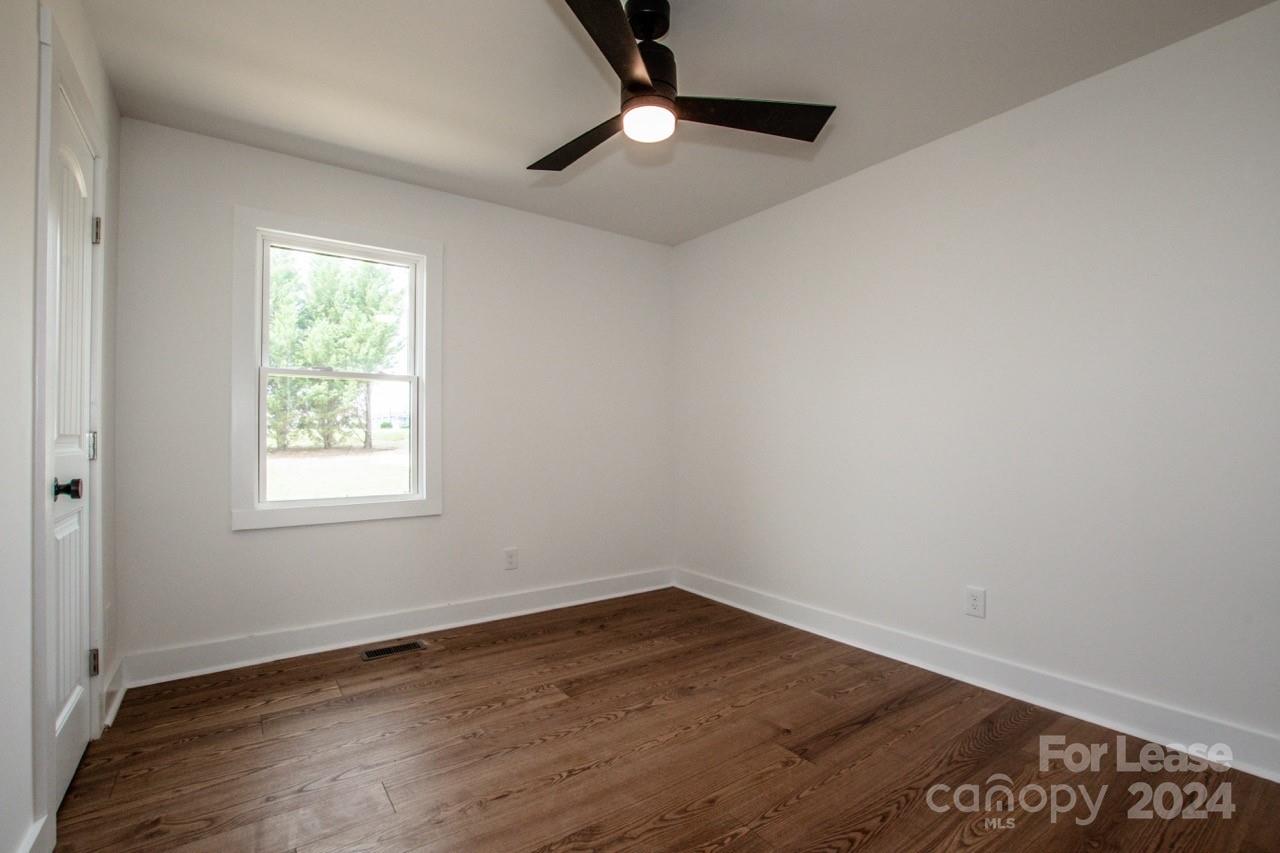 4892 Highway 16 Denver, NC 28037 - Photo 34 of 46 wooden floor in an empty room with a window